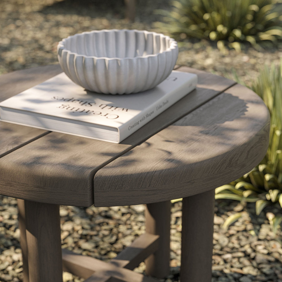 Eleni 20-Inch Round Outdoor Teak Wood Side Table with a white ribbed ceramic bowl on surface on Tampa Home & Garden Store