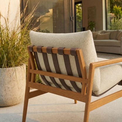 Nomi outdoor teak wood sling chair with beige cushion and leather straps on teak frame on Tampa Home & Garden Store