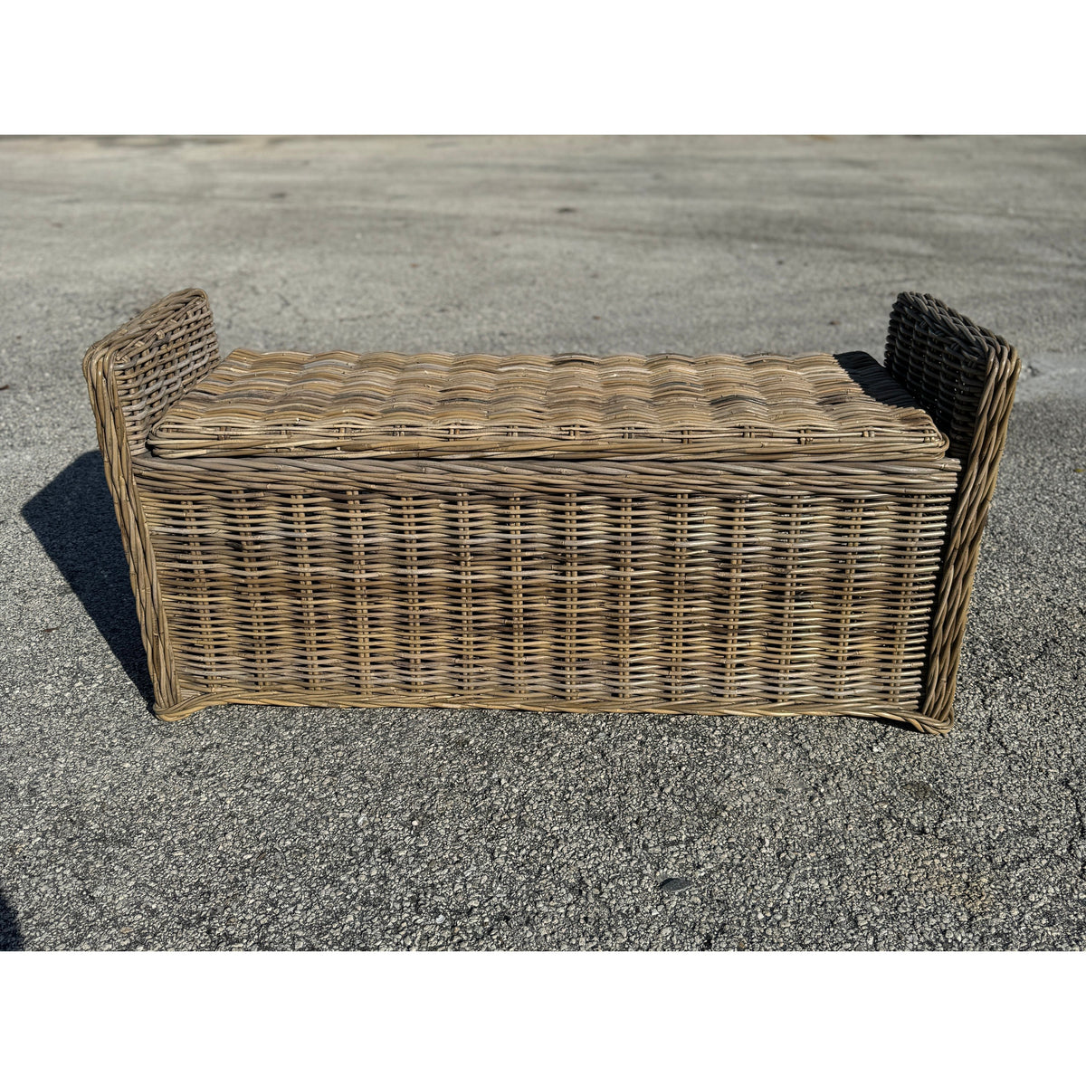 Key Largo Rattan Storage Bench by The Broward Design Center, tan woven bench on asphalt on Tampa Home & Garden Store