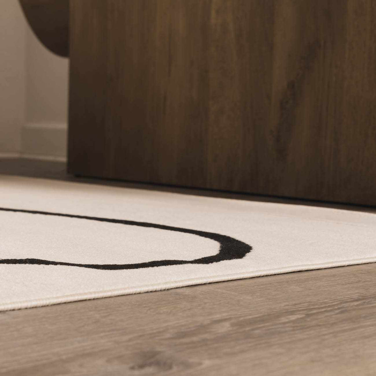 Eilir Modern Low Profile Boho Rug, ivory with black circular ring motif, Boutique Rugs on Tampa Home & Garden Store