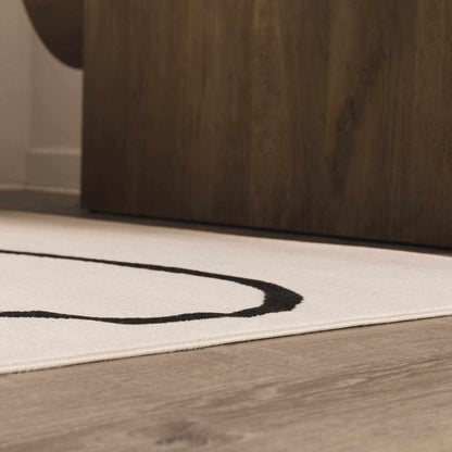 Eilir Modern Low Profile Boho Rug, ivory with black circular ring motif, Boutique Rugs on Tampa Home & Garden Store