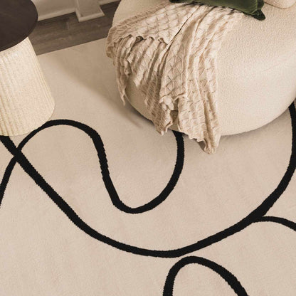 Eilir Modern Low Profile Boho Rug in cream with bold black curved lines, Boutique Rugs on Tampa Home & Garden Store