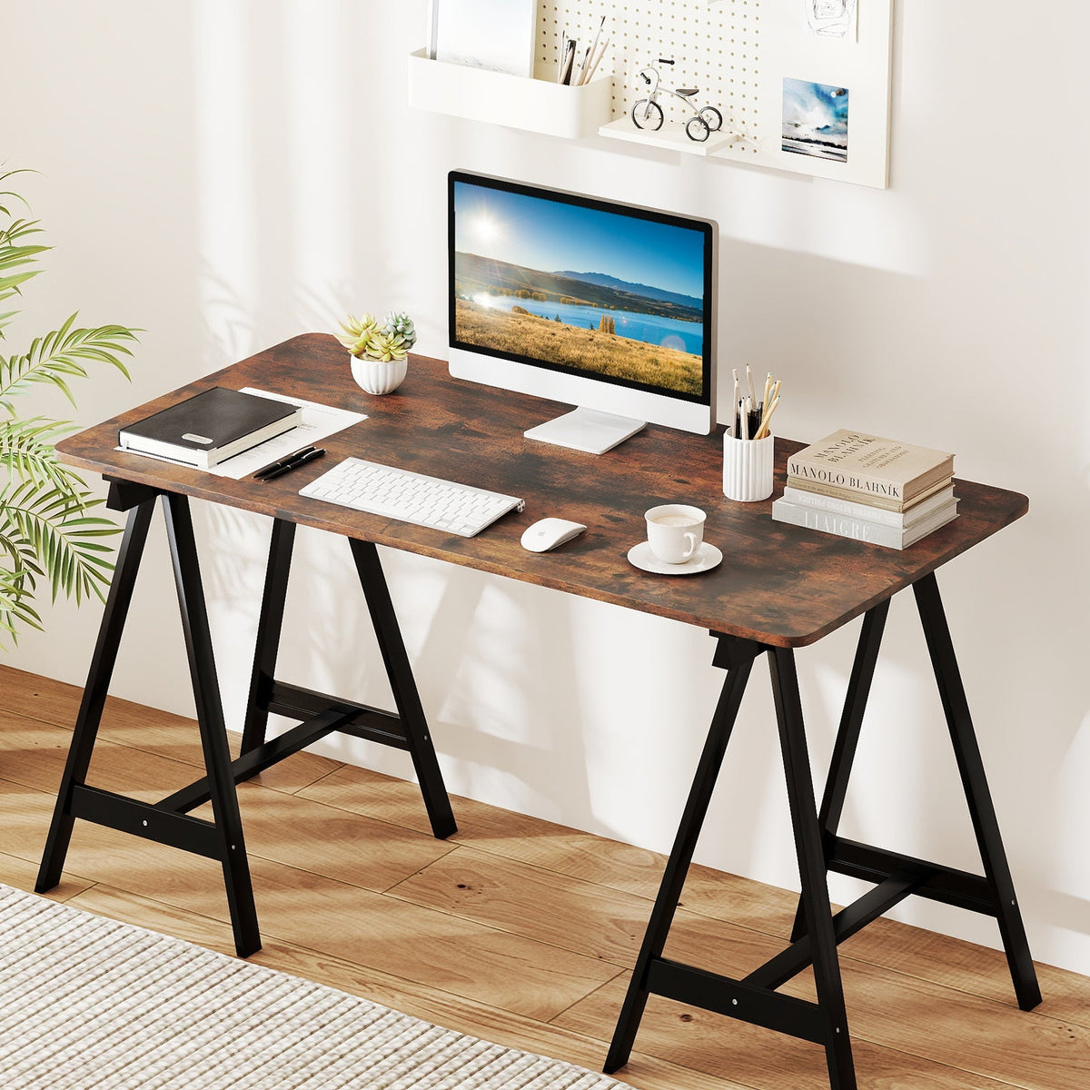 Home office desk with a wide monitor, keyboard, mouse, small plant, notebook stack and cup on Tampa Home & Garden Store