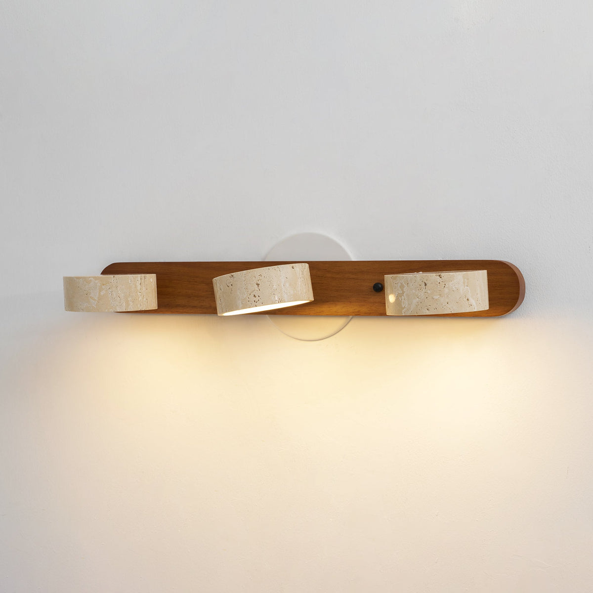 Travertine stone wall sconce with three cylindrical shades on wood backer, dimmable LED on Tampa Home & Garden Store