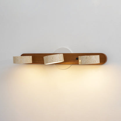 Travertine stone wall sconce with three cylindrical shades on wood backer, dimmable LED on Tampa Home & Garden Store