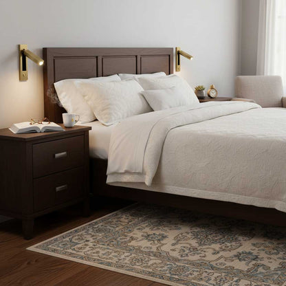 Recessed folding bedside wall sconce with warm LED, brass finish, pair by a dark wood bed on Tampa Home & Garden Store