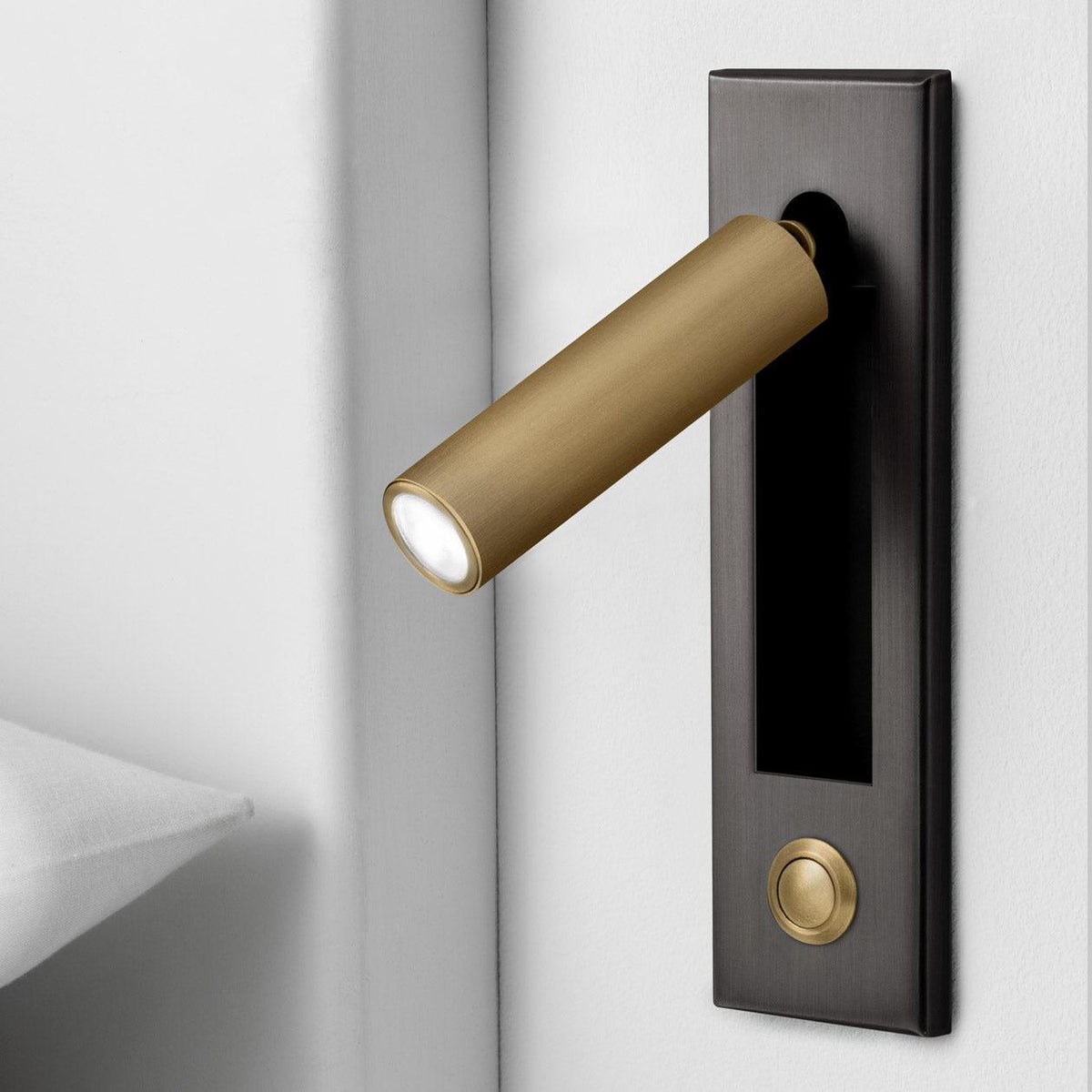Brass recessed bedside wall sconce with warm LED, cylindrical shade on dark backplate on Tampa Home & Garden Store