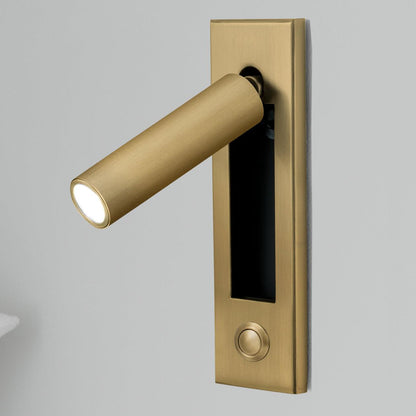 Bedside wall sconce in brass with cylindrical warm LED light on a rectangular backplate on Tampa Home & Garden Store