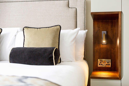 Recessed Folding Bedside Wall Sconce by Moktan Sabai with warm LED on a wooden bedside panel on Tampa Home & Garden Store