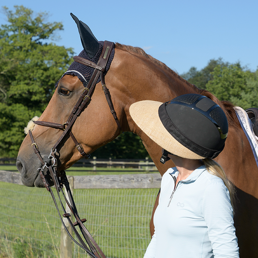 EquiVisor Natural Jute Sun Visor worn by rider beside horse, beige brim, EquiVisor brand on Tampa Home & Garden Store