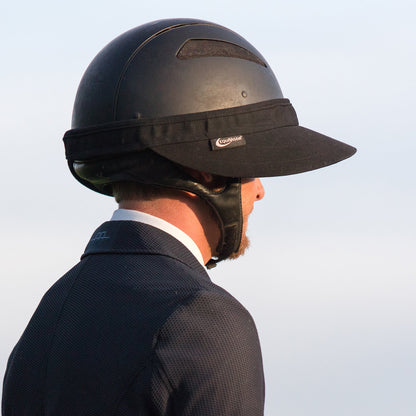 EquiVisor Original Shorty 3 sun visor on black riding helmet worn by a rider in a dark jacket on Tampa Home & Garden Store
