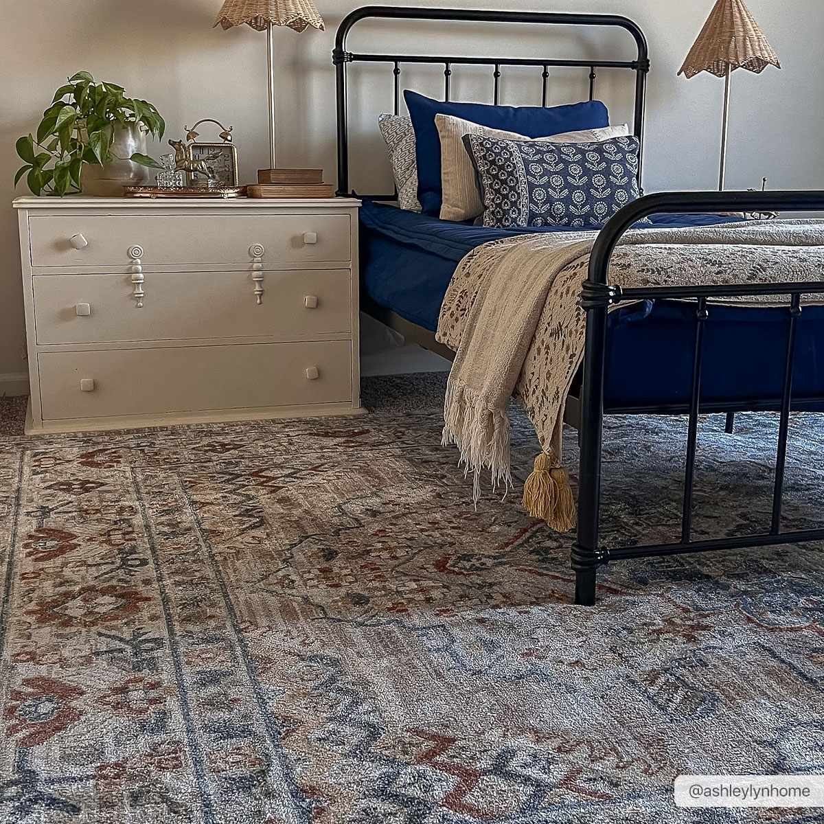 Erez Flat Pile Washable Rug Boutique Rugs in blue beige tones under a black metal bed on Tampa Home & Garden Store