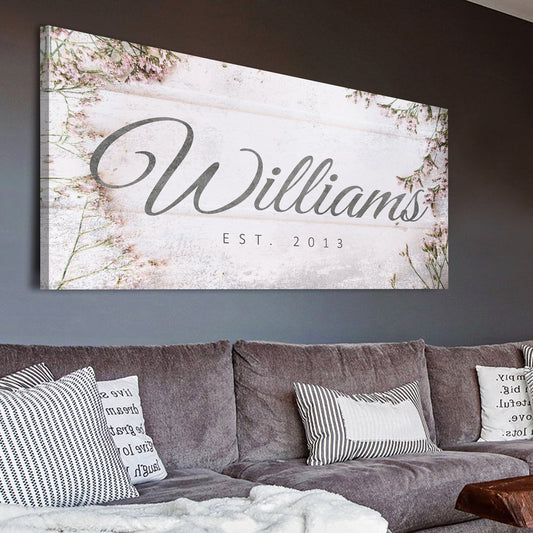 Family Name Sign canvas with whitewashed wood backdrop and pink floral accents Williams script on Tampa Home & Garden Store