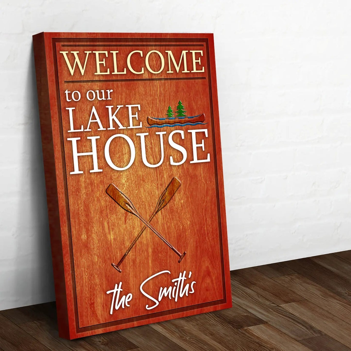 Welcome To Our Lake House Sign canvas with white text and wood finish, The Smith's logo on bottom on Tampa Home & Garden Store