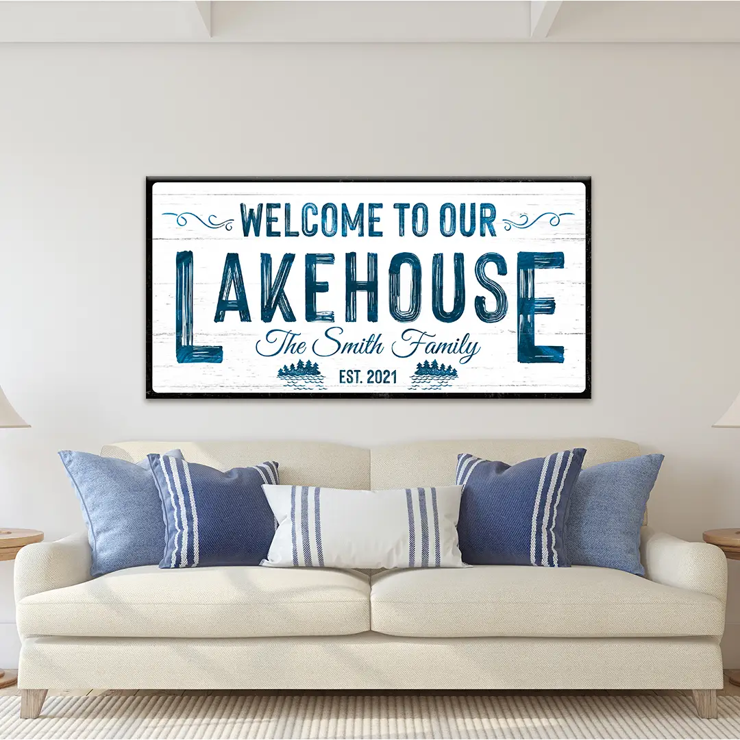 Canvas sign Welcome To Our Lakehouse with blue distressed lettering on white wood, black frame on Tampa Home & Garden Store