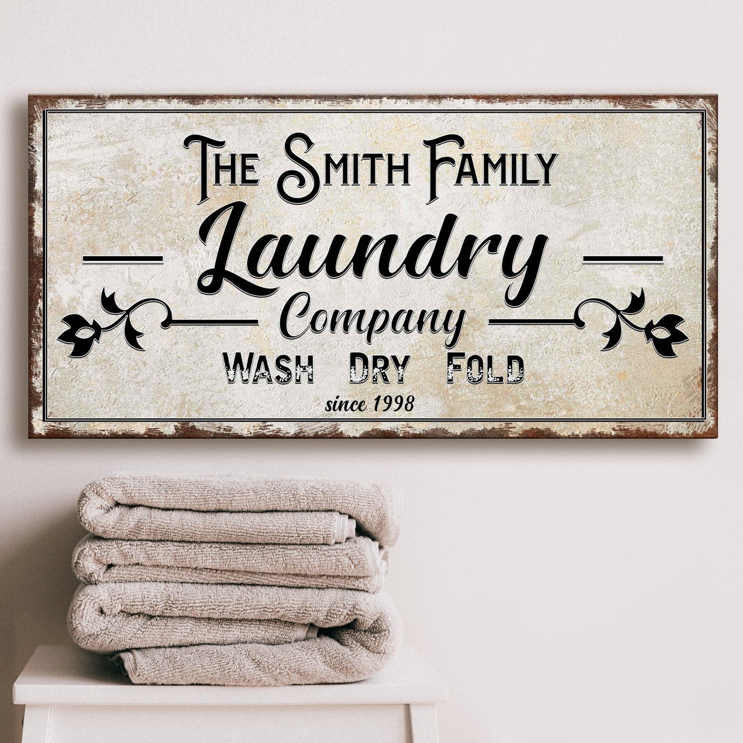 Canvas sign reading Smith Family Laundry Company Wash Dry Fold with rustic frame on Tampa Home & Garden Store