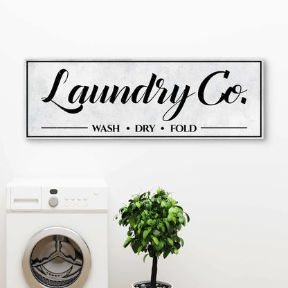 Laundry Co canvas sign by Tailored Canvases; black script text with wash dry fold lines on Tampa Home & Garden Store