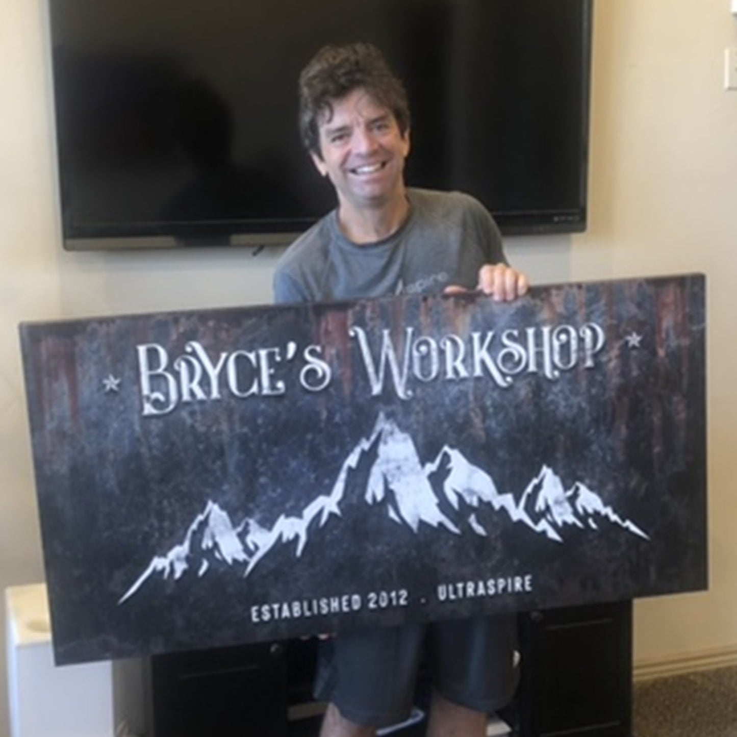 Family Mountain Home Sign canvas with white mountain graphic and Bryce's Workshop lettering on Tampa Home & Garden Store