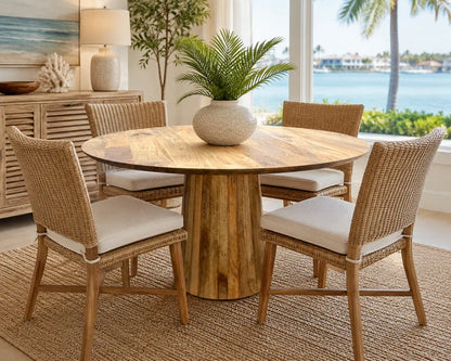 Round mango wood dining table with pedestal base and four wicker chairs with cushions on Tampa Home & Garden Store