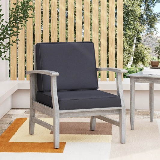 Perla Club Chair light grey lounge chair with cushions and light wood frame on a patio on Tampa Home & Garden Store