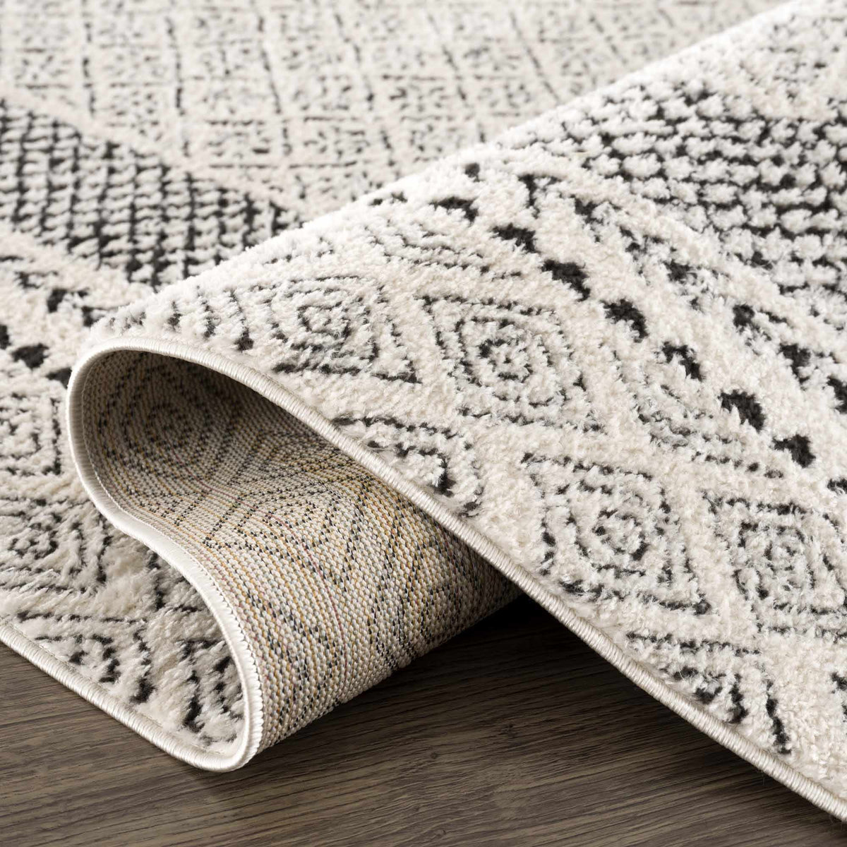 Julio Area Rug beige with black lattice pattern, rolled edges Boutique Rugs on Tampa Home & Garden Store