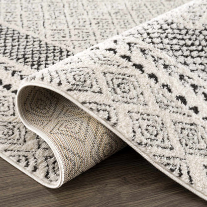 Julio Area Rug beige with black lattice pattern, rolled edges Boutique Rugs on Tampa Home & Garden Store