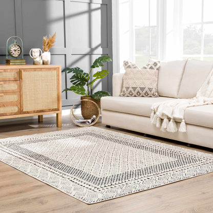 Julio area rug by Boutique Rugs with black and ivory geometric pattern in a bright living room on Tampa Home & Garden Store