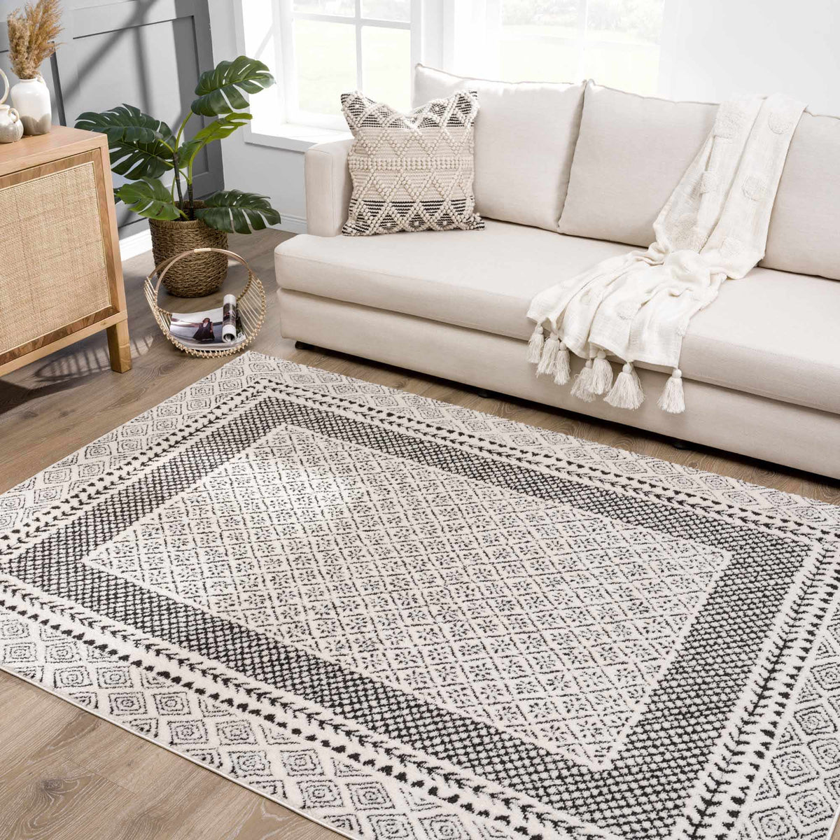 Julio Area Rug by Boutique Rugs, black and white geometric rug in a bright living room on Tampa Home & Garden Store