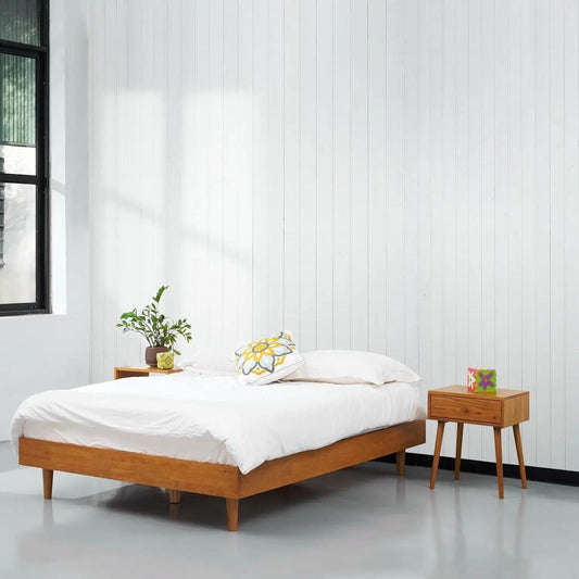 Full size mid-century platform bed in light wood with white bedding and two nightstands on Tampa Home & Garden Store
