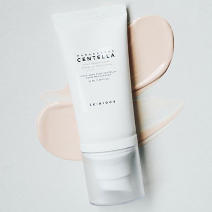 Skin1004 Madagascar Centella Sunscreen SPF 50+ PA++++ white tube with flip cap and peach swirls on Tampa Home & Garden Store