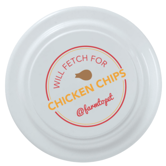 Frisbee dog toy Farm To Pet white disc with Will Fetch for Chicken Chips label on Tampa Home & Garden Store