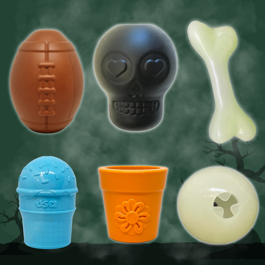 Dog treat dispensers by Farm To Pet set in orange football, black skull, blue ribbed cup on Tampa Home & Garden Store