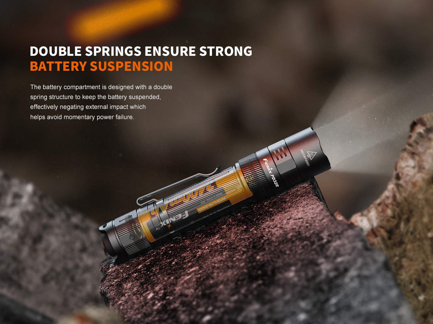 Fenix PD32R rechargeable LED tactical flashlight with silent switch resting on a rock on Tampa Home & Garden Store