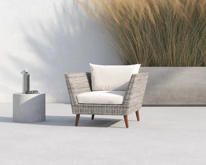 Panther Outdoor Patio Wicker Chair with white cushions and FSC wood legs on concrete patio on Tampa Home & Garden Store