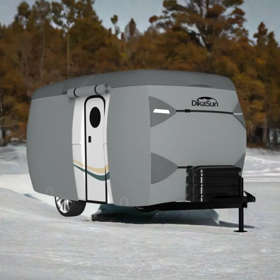 7-layer fiberglass travel trailer cover by Dikasun Outdoor on a gray RV in snowy landscape on Tampa Home & Garden Store