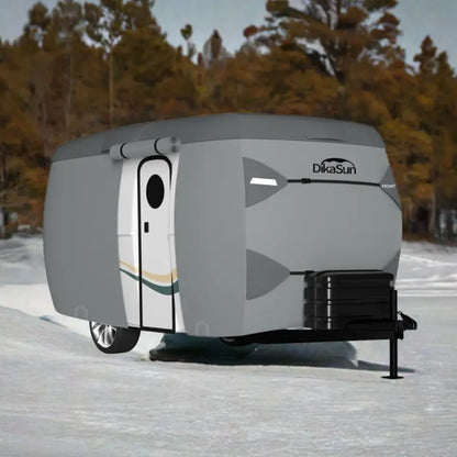 7-layer fiberglass travel trailer cover by Dikasun Outdoor on a gray RV in snowy landscape on Tampa Home & Garden Store