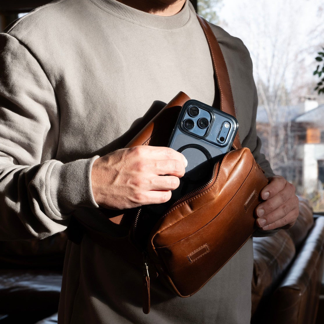 The Field Belt Bag by Will Leather Goods brown leather fanny pack holding a smartphone on Tampa Home & Garden Store