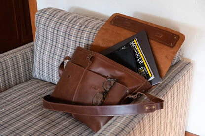 Field Messenger bag by Will Leather Goods brown leather with strap on plaid couch on Tampa Home & Garden Store