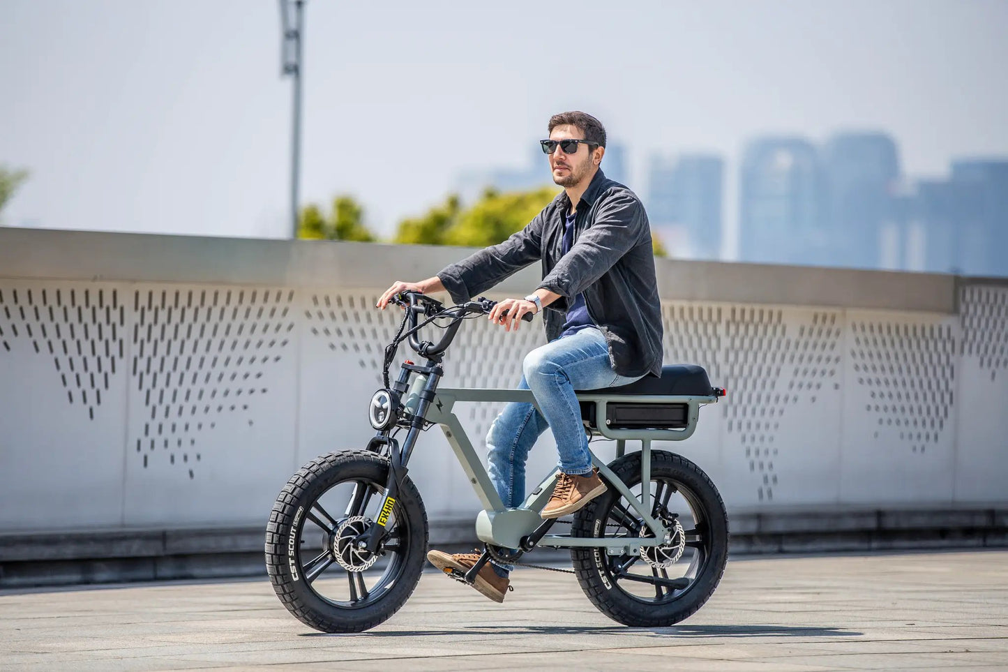 FLASH AWD 1.0 electric bicycle by EUNORAU E-BIKE US, olive frame, fat tires, rider in sunglasses on Tampa Home & Garden Store