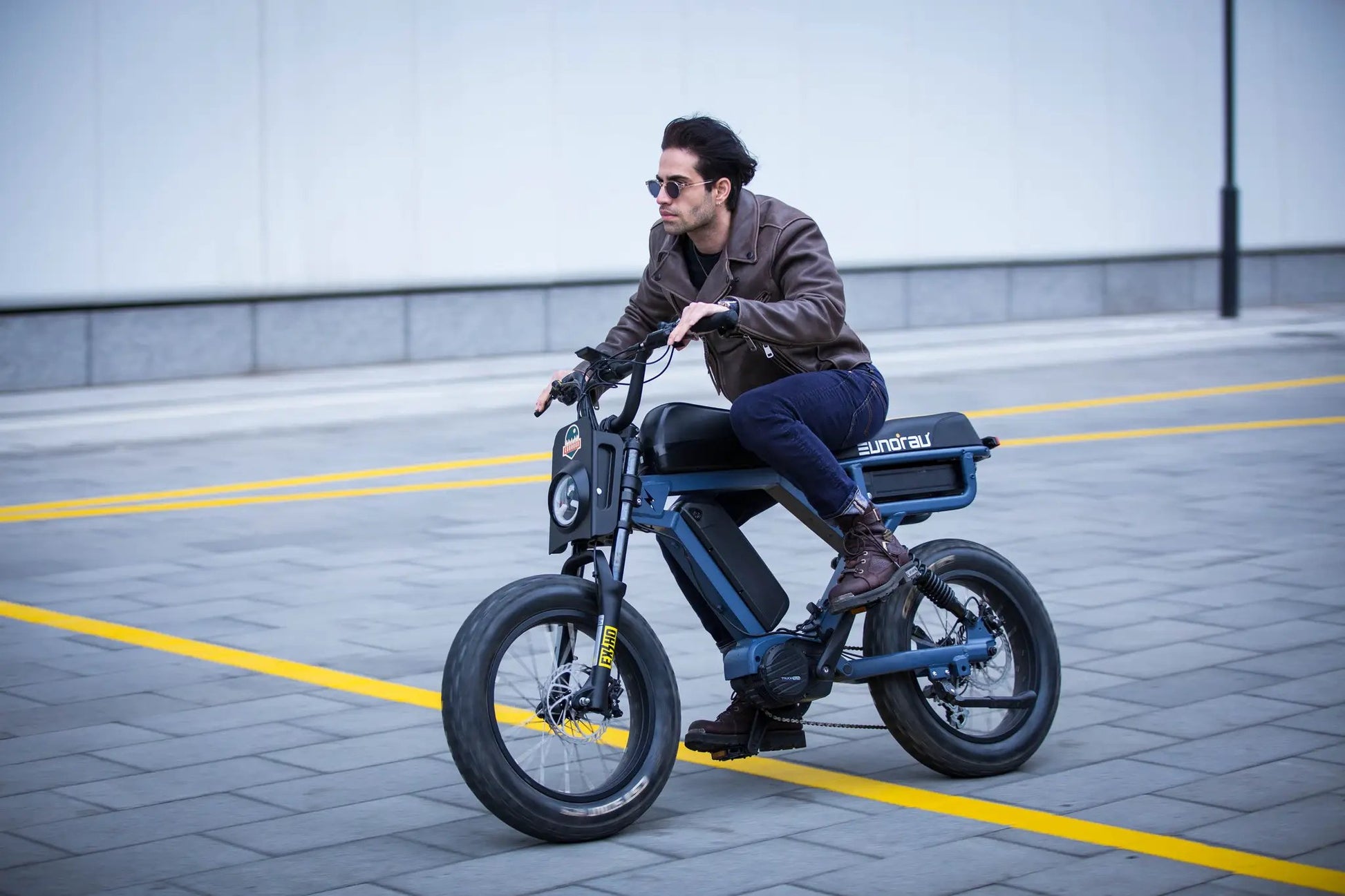 FLASH LITE 2.0 electric bike blue frame rider wearing brown leather jacket by EUNORAU E-BIKE US on Tampa Home & Garden Store