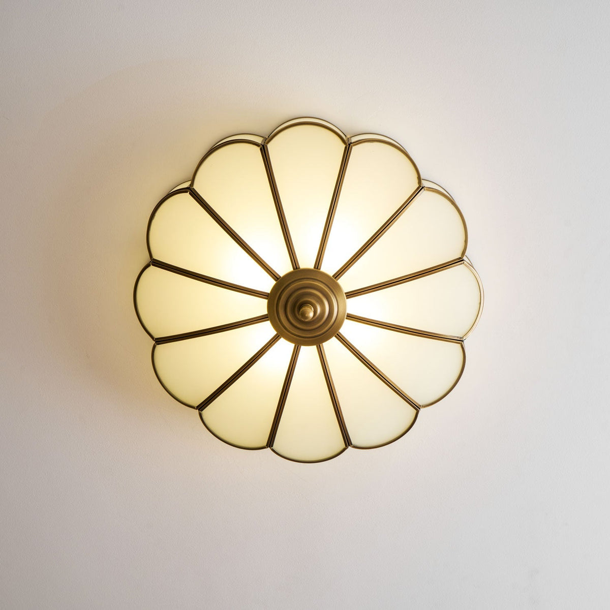 Flower-shaped frosted glass ceiling light with brass frame by Moktan Sabai, soft ambient glow on Tampa Home & Garden Store