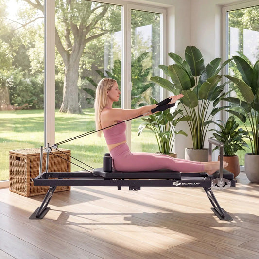 Foldable Pilates reformer for home gym; pink-clad woman sits on carriage with resistance cords on Tampa Home & Garden Store