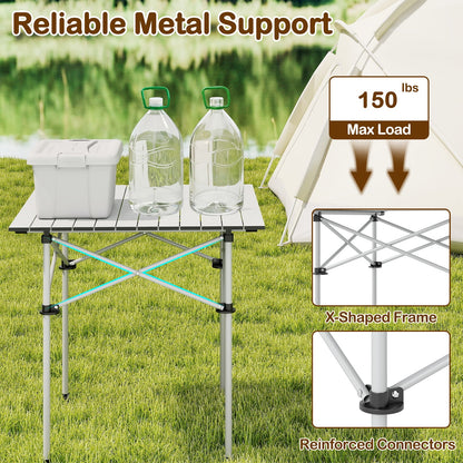 GemGear Folding Roll-up Camping Table with metal legs and X-shaped frame on a grassy campsite on Tampa Home & Garden Store