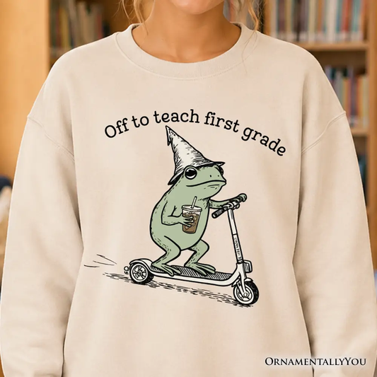 Off to Teach First Grade Frog Sweatshirt beige with frog on scooter sipping coffee OrnamentallyYou on Tampa Home & Garden Store