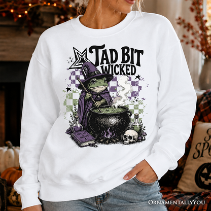 Tad Bit Wicked Frog Witch Sweatshirt in white with purple cauldron by OrnamentallyYou on Tampa Home & Garden Store