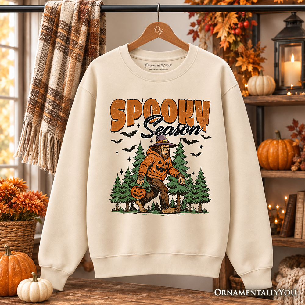 Spooky Season Bigfoot Sweatshirt orange SPOOKY text pumpkin Sasquatch among trees OrnamentallyYou on Tampa Home & Garden Store