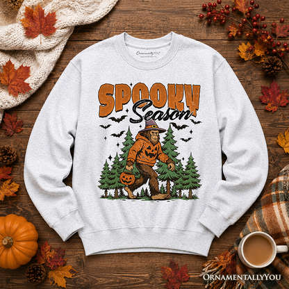 Sweatshirt Spooky Season Bigfoot with orange pumpkin Sasquatch on gray heather OrnamentallyYou on Tampa Home & Garden Store