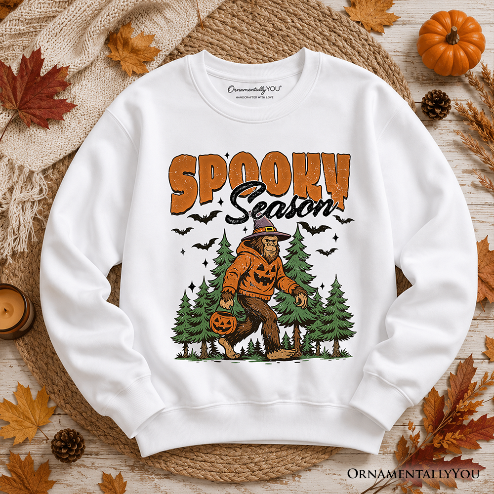 White sweatshirt by OrnamentallyYou with Spooky Season Bigfoot Sasquatch among trees and bats on Tampa Home & Garden Store