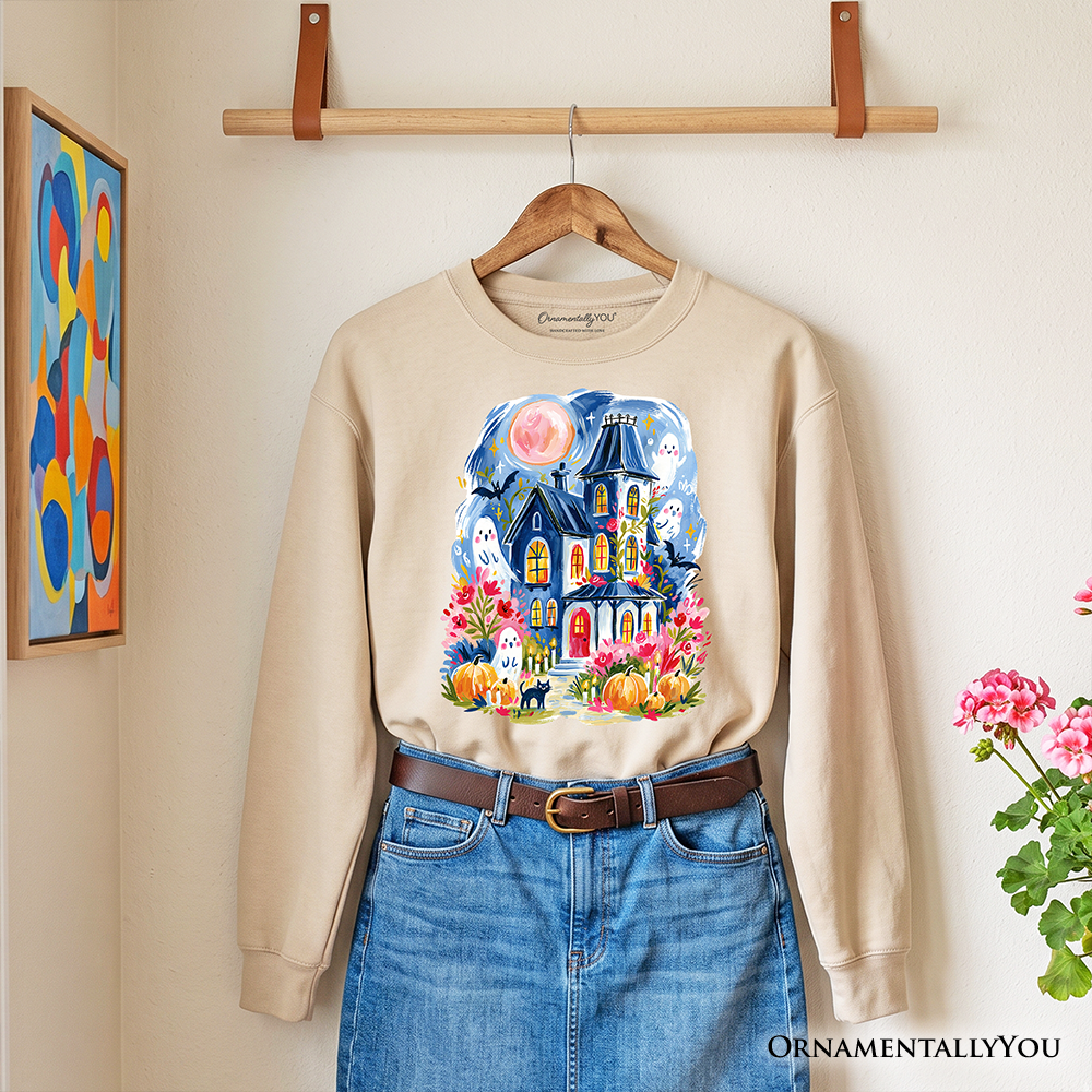 Watercolor Haunted House Sweatshirt beige with ghost and pumpkin artwork by OrnamentallyYou on Tampa Home & Garden Store