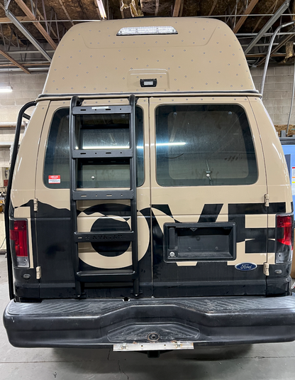 Ford E-Series rear ladder by avatar offroad, black steel ladder mounted on tan high-roof van rear on Tampa Home & Garden Store